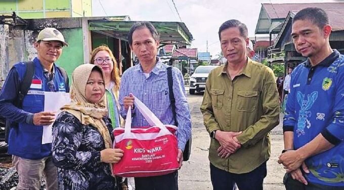 SALURKAN BANTUAN: Anggota DPRD Barito Utara, Patih Herman (tiga dari kanan) dampingi Pj Bupati Muhlis (dua dari kanan) dan Kadinsos PMD Suparmi A Aspian (paling kanan) menyerahkan bantuan kepada warga, Sabtu (10/5).