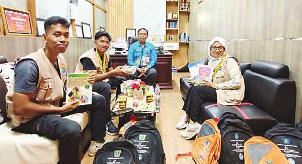 KAPUAS BERSINERGI: Kepala Disdik Kapuas Dr Suwarno Muriyat bersama satu kelompok mahasiswa yang bertugas di Desa Palangkau Baru di ruang kerjanya, Jumat (25/7) sore.