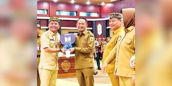 PALANGKA RAYA TERIMA KUNCI: Wali Kota Palangka Raya, Fairid Naparin menerima kunci truk angkutan sampah dari Gubernur Kalimantan Tengah, H Agustiar Sabran usai penandatanganan Optimalisasi PAD Sektor Pertambangan Tahun 2025, di Aula Jayang Tingang, Selasa (21/10).