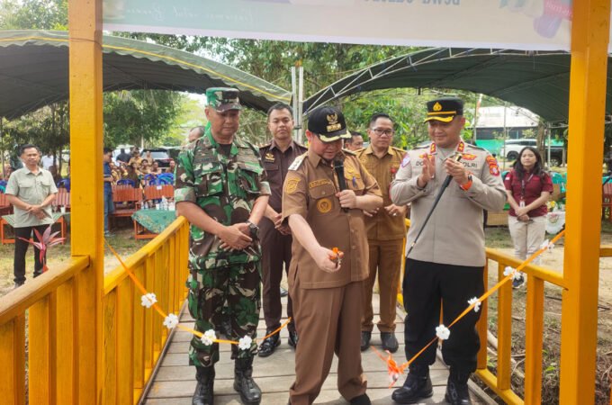PEMBUKAAN: Bupati Katingan Saiful menguntingkan pita sebagai tanda dibukanya untuk umum kolam pemancingan yang ada di Kebun Raya Katingan, Senin (26/1)