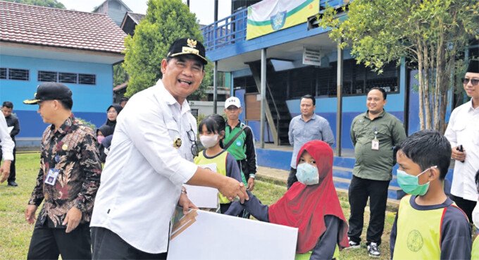 Bupati Barito Utara, H Shalahuddin ST MT secara simbolis menyerahkan bantuan pendidikan program SIP Pintar Peduli dan SIP Pintar Juara kepada siswa SDN Benangin, Jumat (18/9).