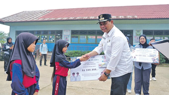 Bupati Barito Utara, H. Shalahuddin secara simbolis memberikan SIP Pintar Juara kepada salah satu siswi SDN 1 Montallat II, Jumat (16/10).
